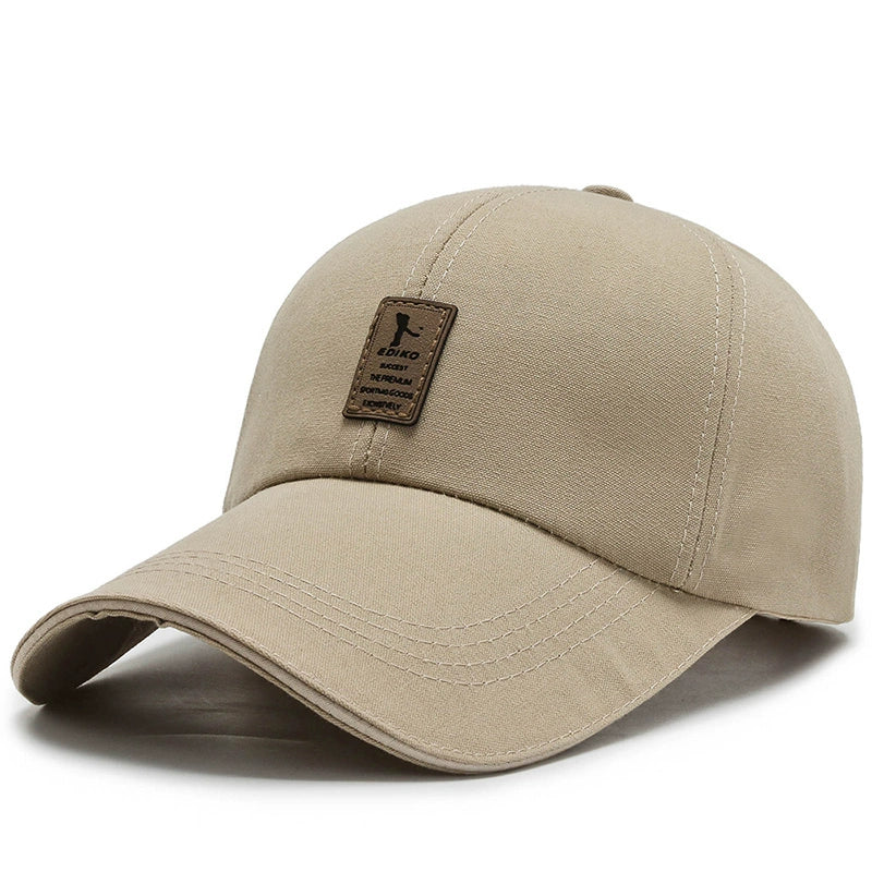 Beige cotton baseball cap with stitched logo patch on front, curved brim, casual style