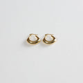 Spade earrings placed on a white background, photographed from a slight angle from the bottom.